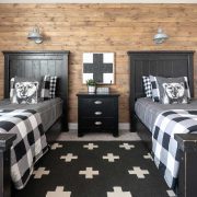 Farmhouse boys’ bedroom with DIY reclaimed wood wall and checked bedding.