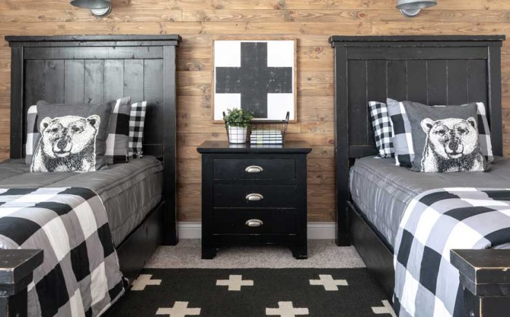 Farmhouse boys’ bedroom with DIY reclaimed wood wall and checked bedding.