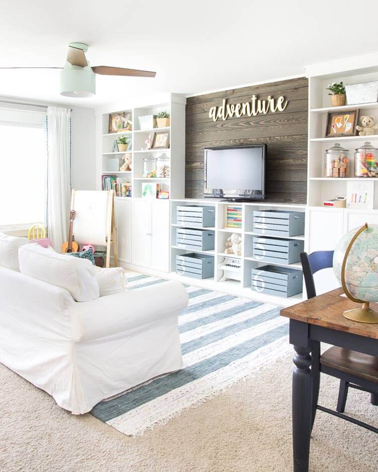 Rustic wood wall in playroom behind TV