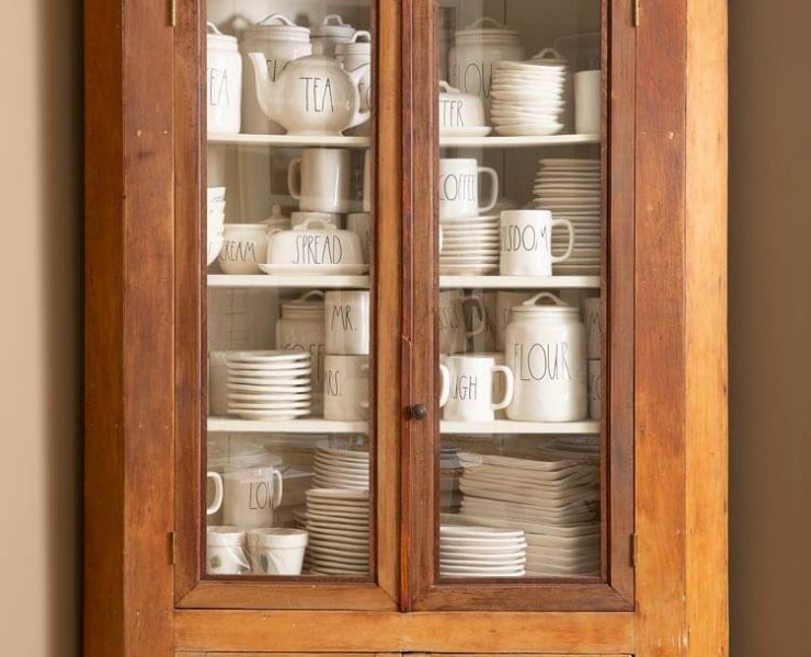 shelf containing rae dunn pottery