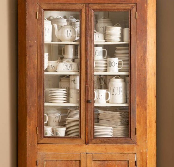 shelf containing rae dunn pottery