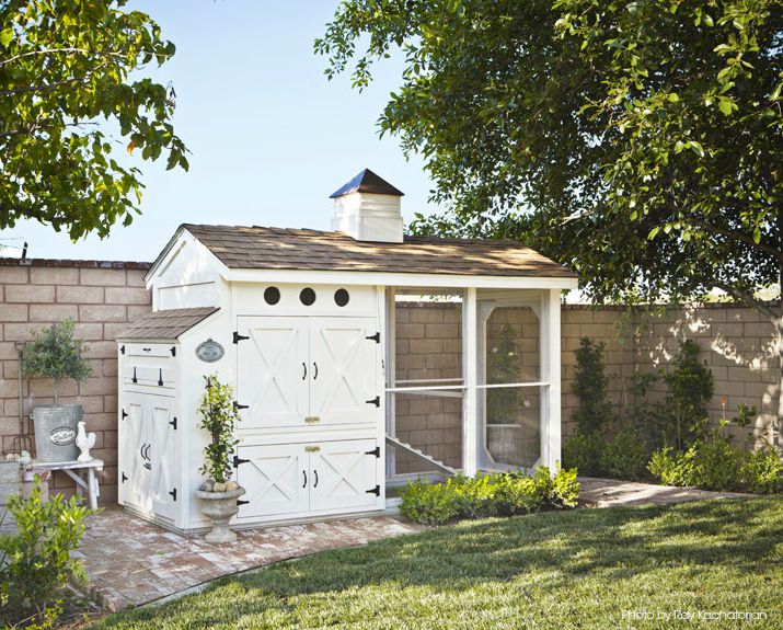 white cute chicken coops with shingle roof and cottage details