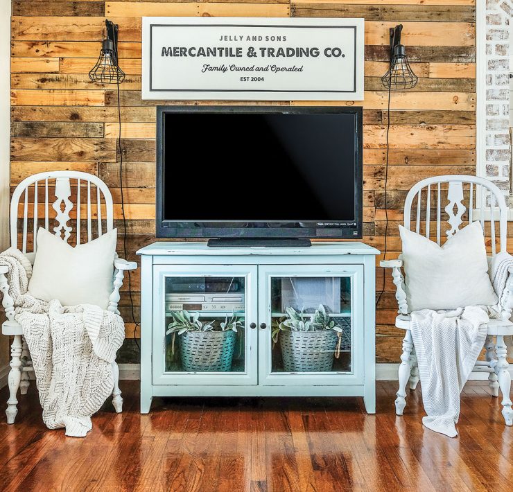 Farmhouse living room with reclaimed wood wall and blue TV stand