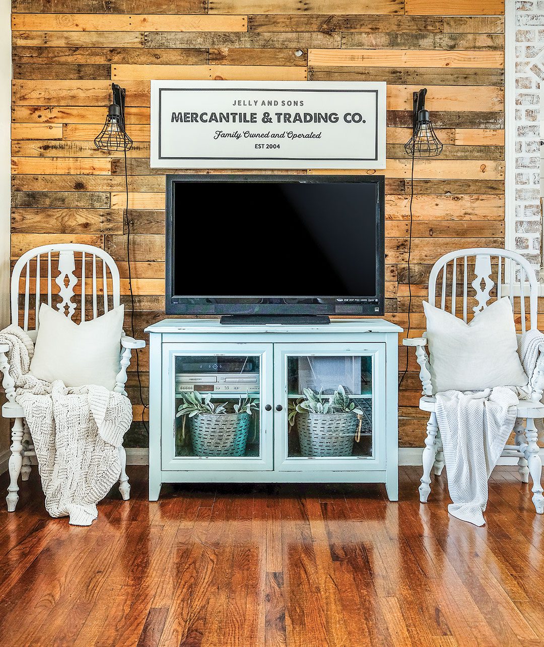 Farmhouse living room with reclaimed wood wall and blue TV stand