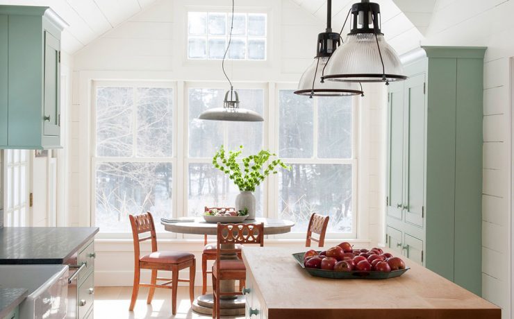 Green kitchen with shiplap walls, butcher block island and shaker cabinets