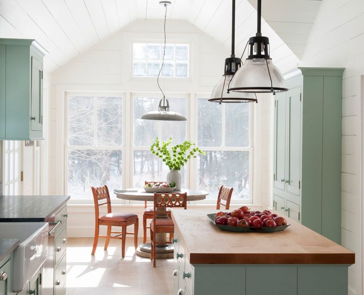 Green kitchen with shiplap walls, butcher block island and shaker cabinets
