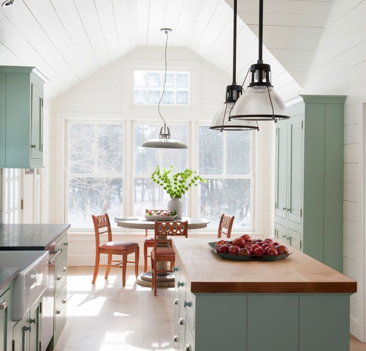 Green kitchen with shiplap walls, butcher block island and shaker cabinets