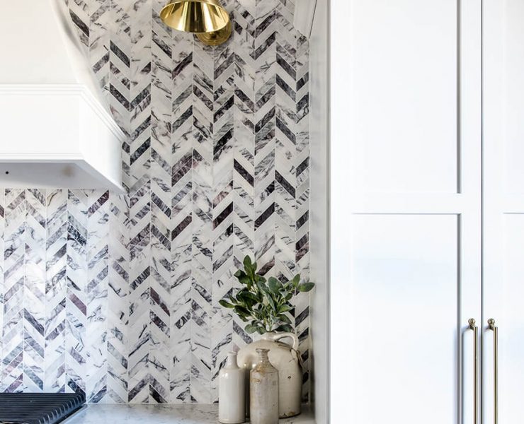 Black and white farmhouse kitchen with herringbone backsplash pattern