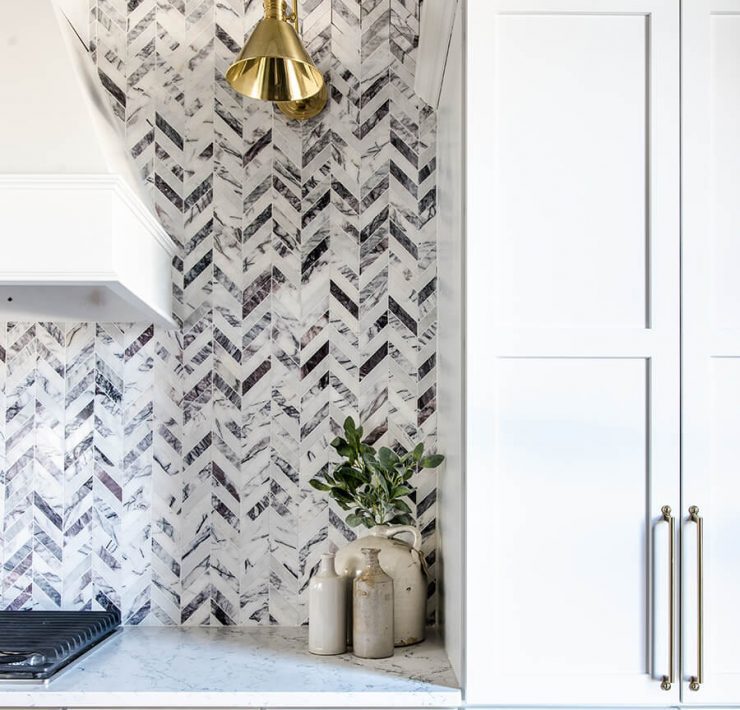 Black and white farmhouse kitchen with herringbone backsplash pattern