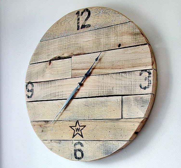 rustic pallet wood clock mounted on a white wall