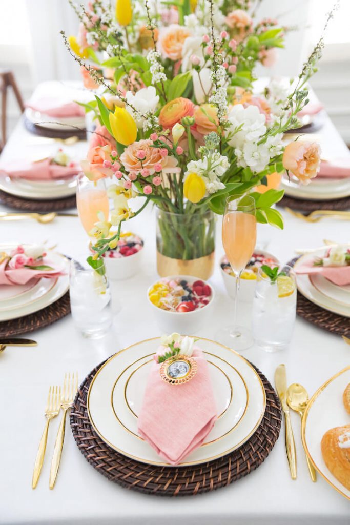 brunch table with pink and yellow accents and yogurt granola bowls