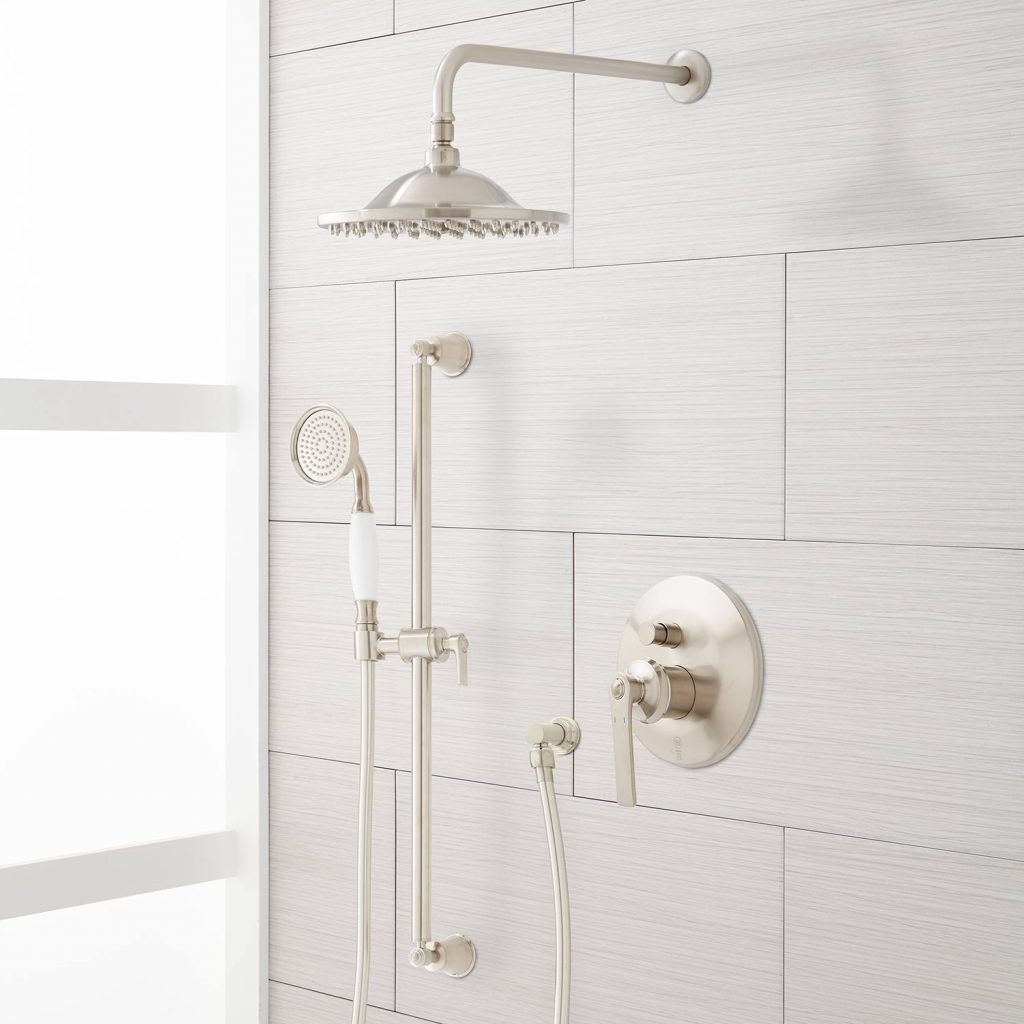 A shower system with faucet and shower head finished with brushed nickel.