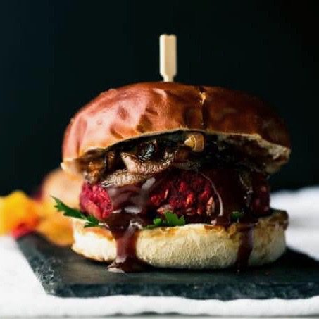 A Fourth of July beet burger oozing with maple barbeque sauce and caramelized onions
