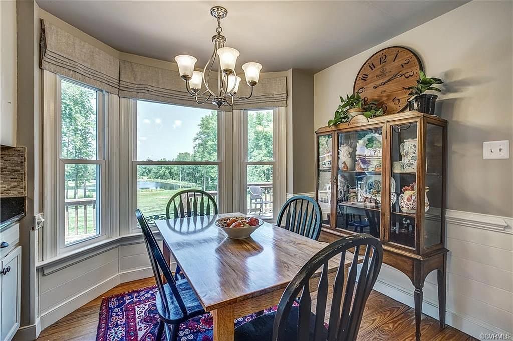 A farmhouse-style kitchen with beautiful views of a lake.