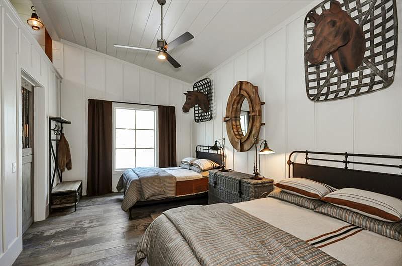 A guestroom features rustic yet edgy decor designed in industrial farmhouse style