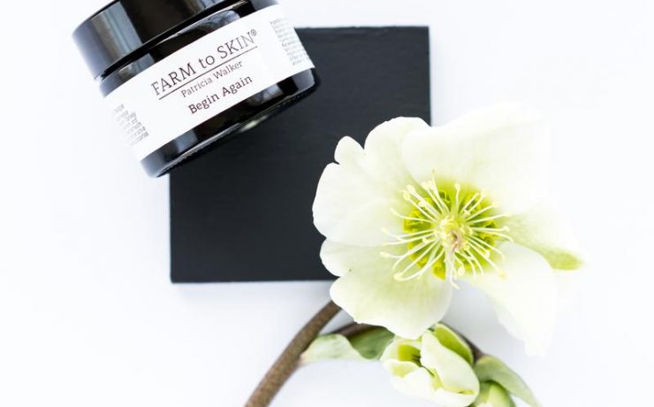 Jar of Farm to Skin masque and a flower.