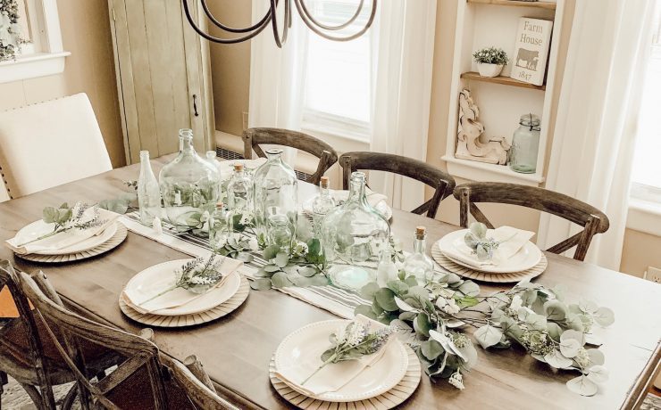 Beautiful upcycled tablescape includes aged bottles and silver dollar eucalyptus leaves