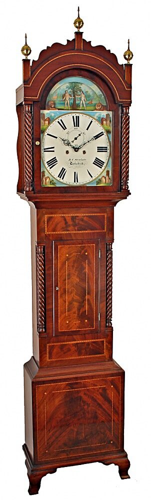 A tall, auburn, antique clock, complete with a decorative hood piece and a hand-painted clock face of the biblical Adam & Eve story