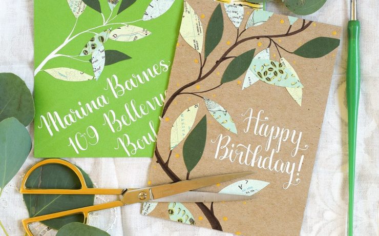 Two birthday cards with leafy designs, fashioned out of newspaper, along a green and brown background