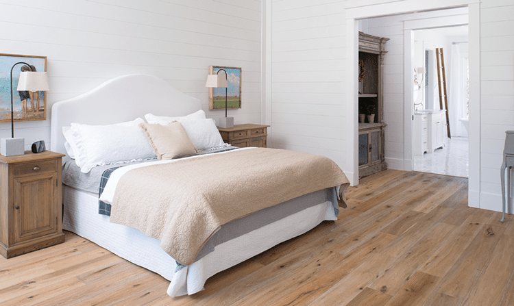 Master bedroom with calm neutral colors in wood paneled farmhouse