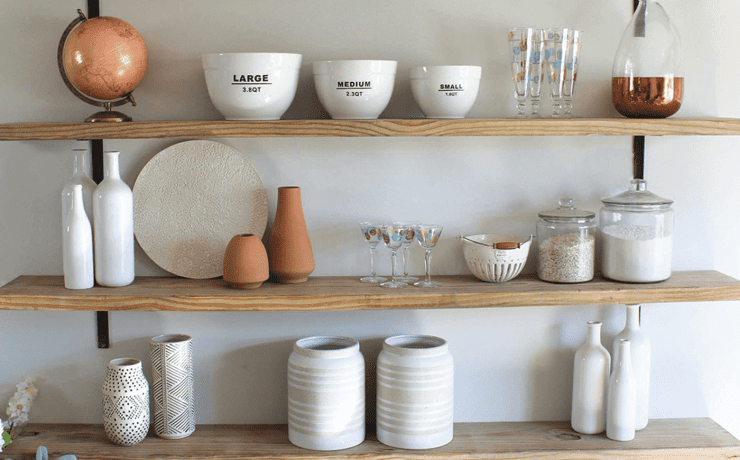 DIY open shelves in a kitchen with pots and bowls on them