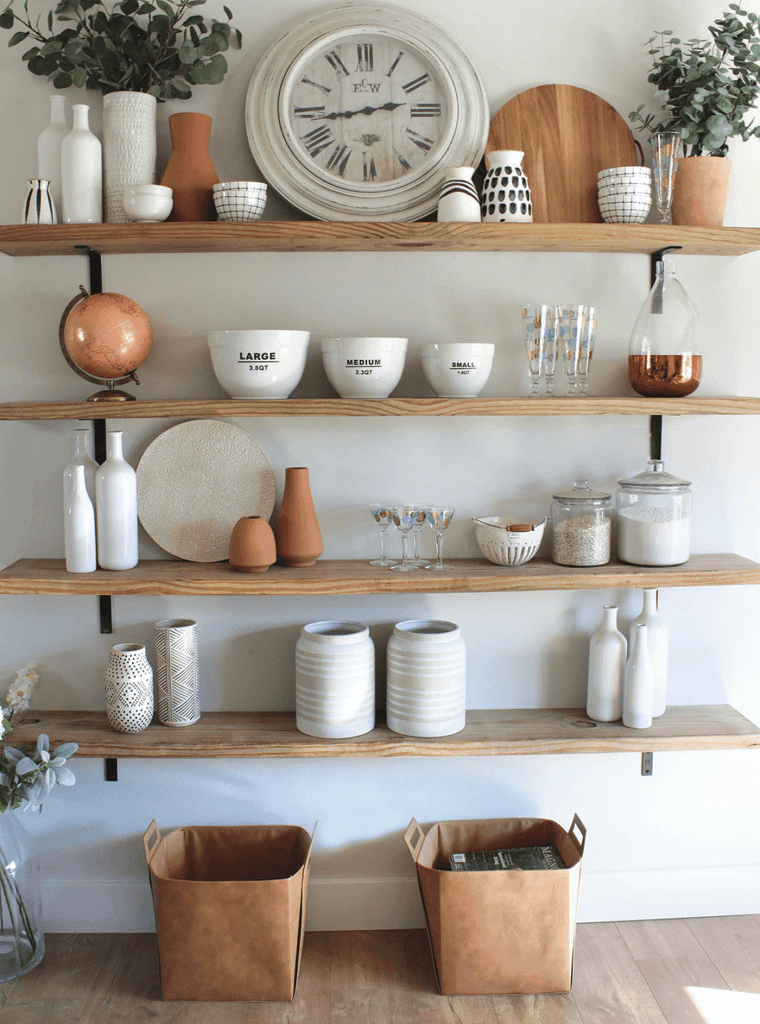 DIY open shelves in a kitchen with pots and bowls on them