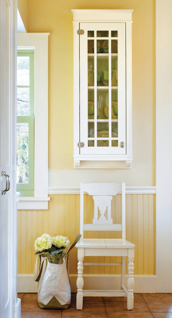 yellow hallway with chair and window in historic farmhouse