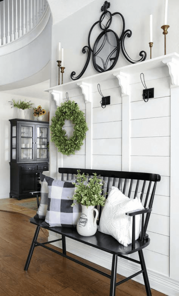 A white foyer with wreaths in a custom farmhouse