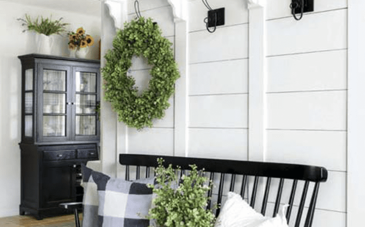 A white foyer with wreaths in a custom farmhouse