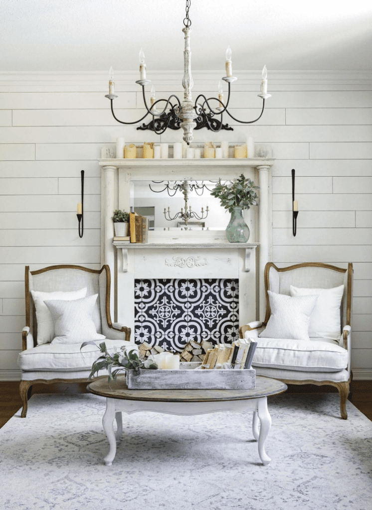 Farmhouse sitting area with farmhouse lighting chandelier and patterned tile.