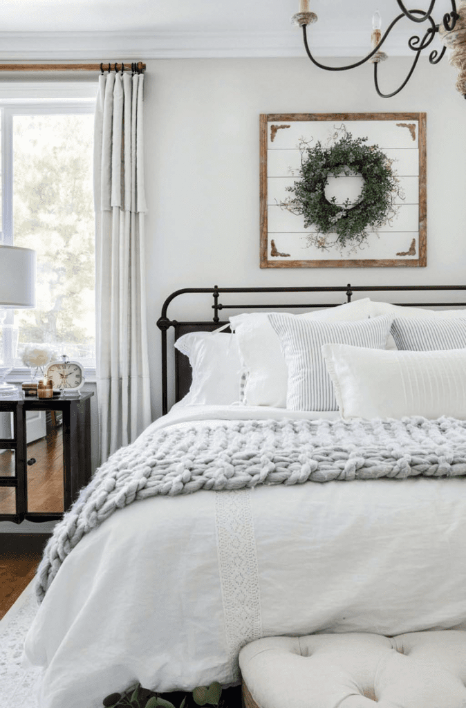Master bedroom with a neutral color palette in a custom farmhouse