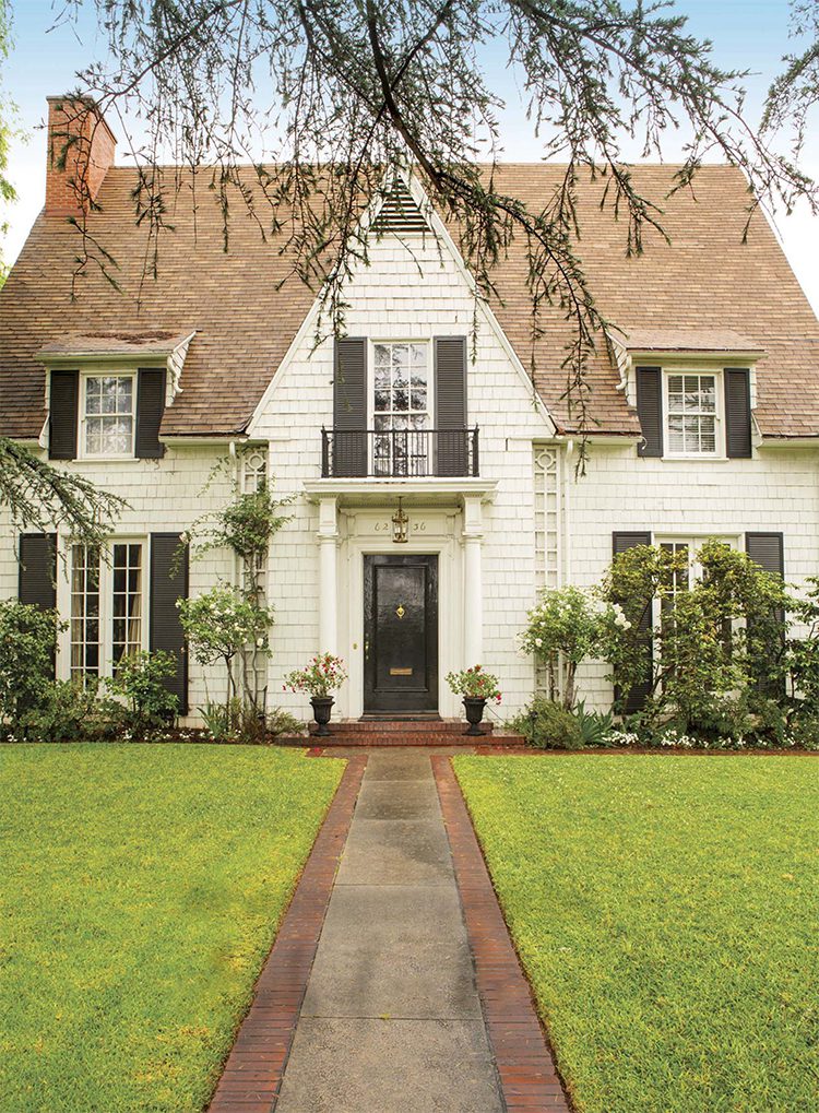 The white exterior of a 100 year old renovated farmhouse