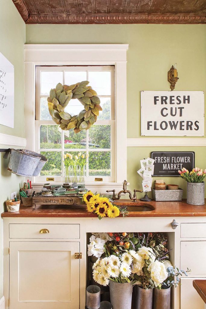 A renovated farmhouse butler's pantry that is now a flower workspace.
