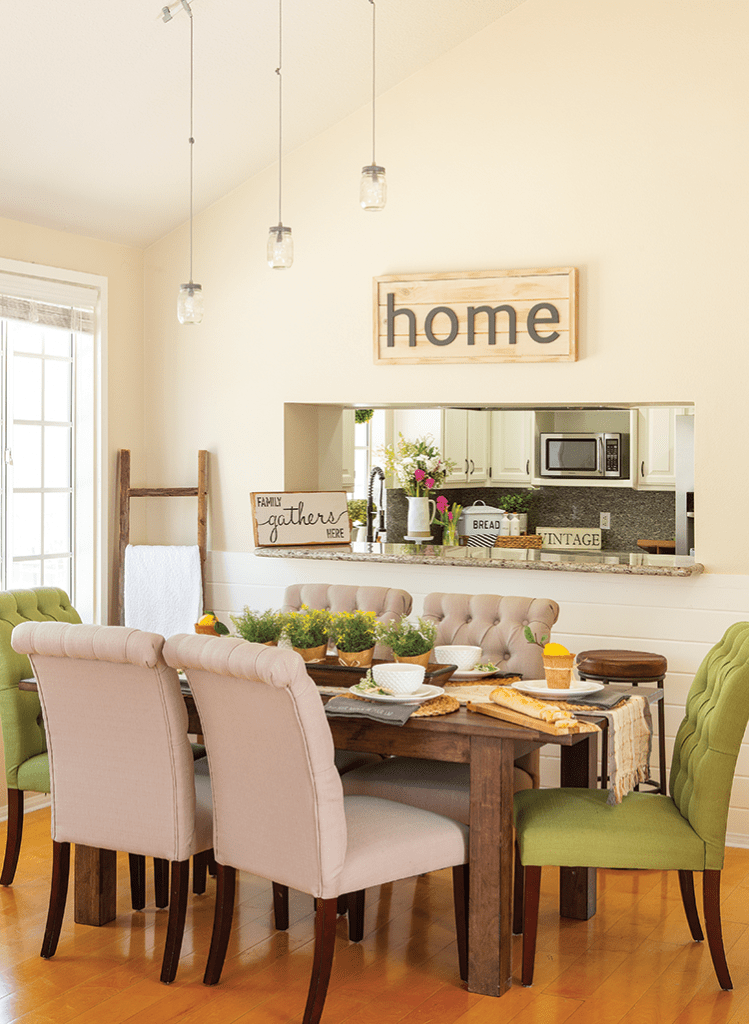 Dining room with farmhouse table, kitchen opening, and farmhouse details.
