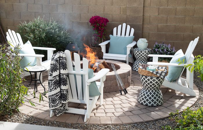 Firepit outdoors with white chairs and s'mores