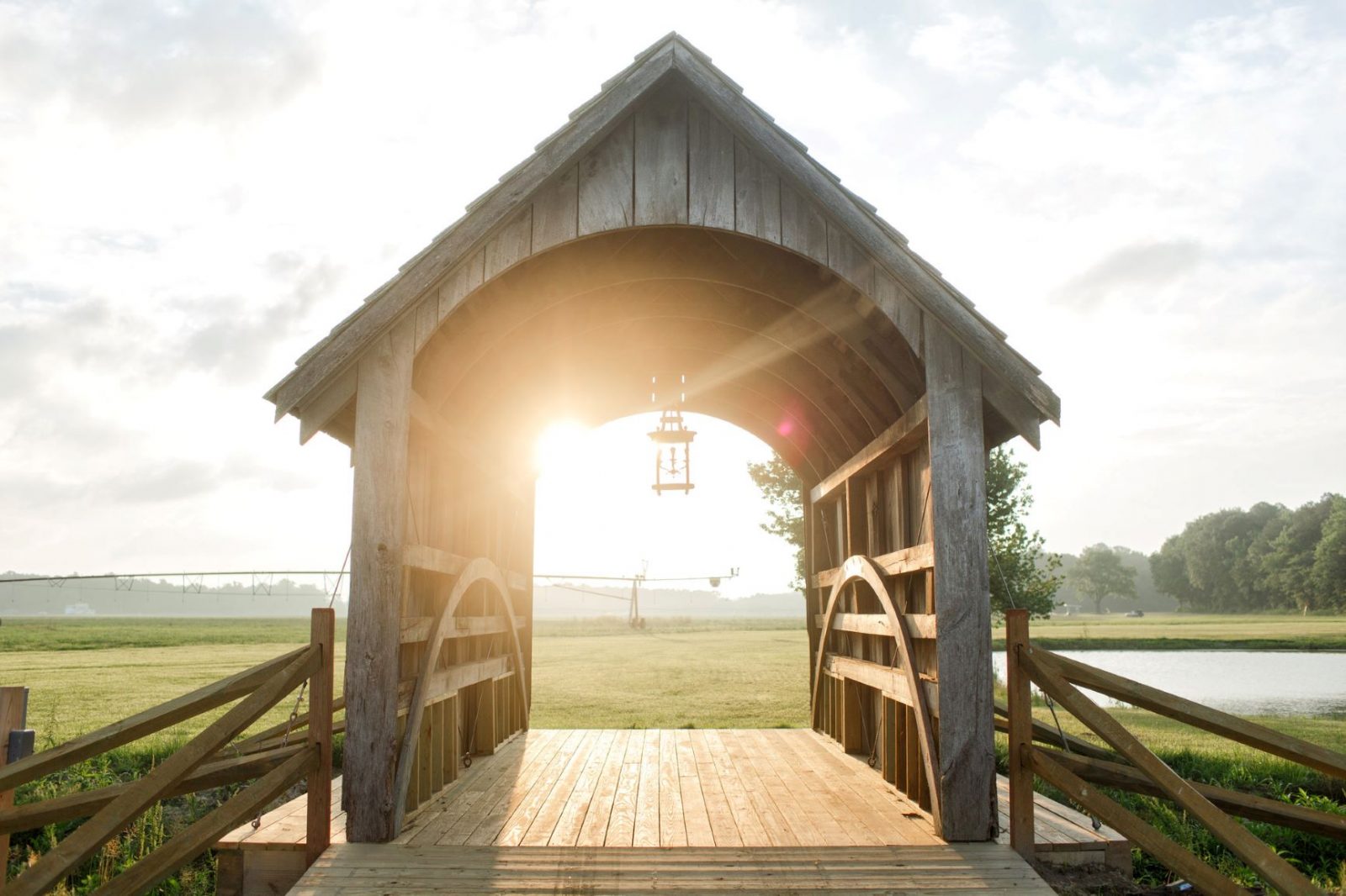 A romantic covered bridge made from aged wood.