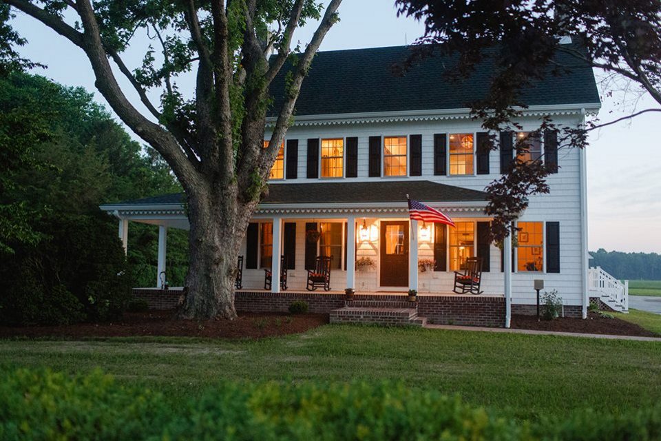 The farmhouse at Covered Bridge Inn. The house is white with dark shutters.