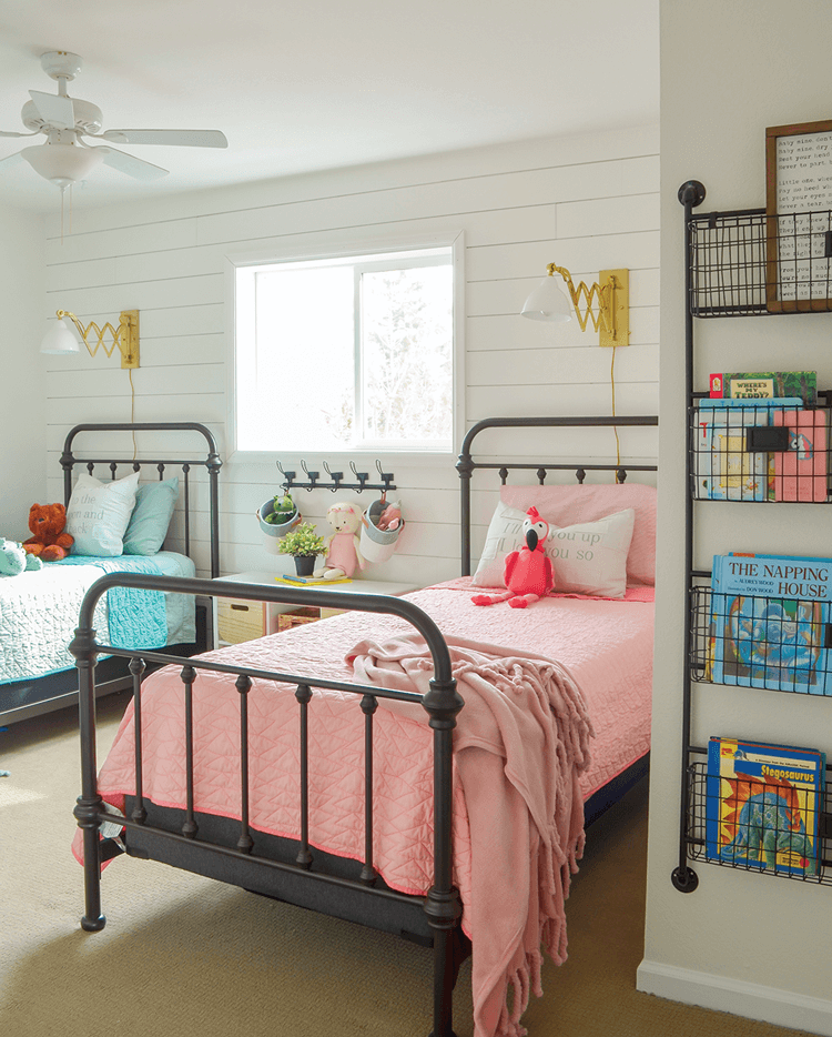 Sarah Joy Blog's kids room with blue and pink bed spread, shiplap walls, and books