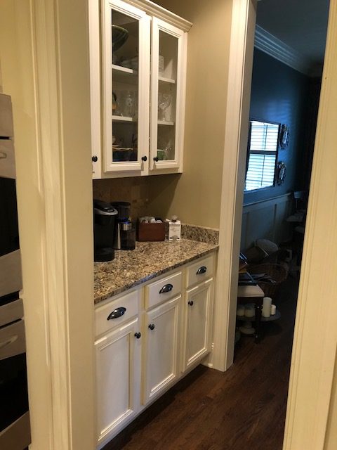 Before the client's remodel: speckled granite countertop in gray color.
