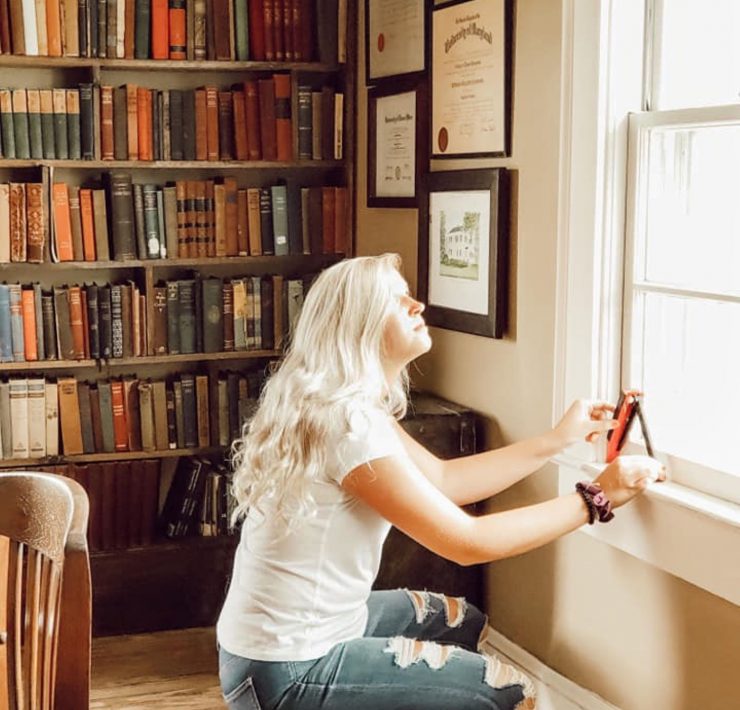 A woman measuring her window with sun comes in