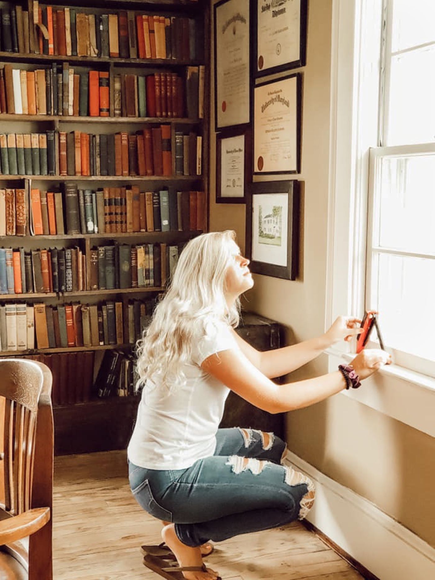 A woman measuring her window with sun comes in