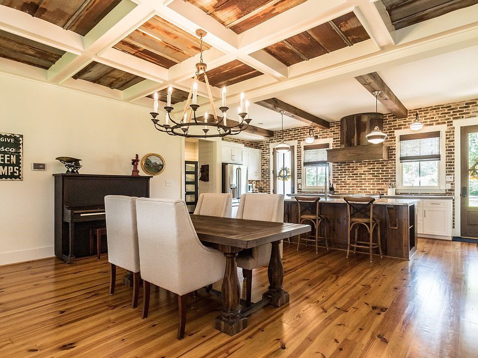 A brick wall offsets the wood floor and ceiling panels.