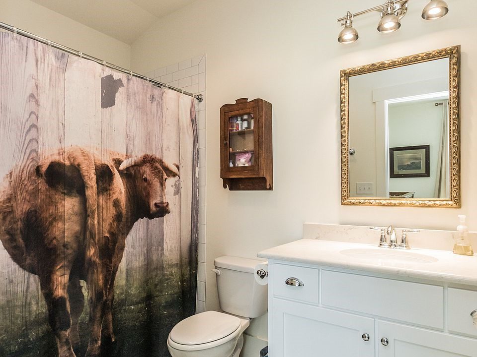 A cow's rear end takes up the majority of this shower curtain.