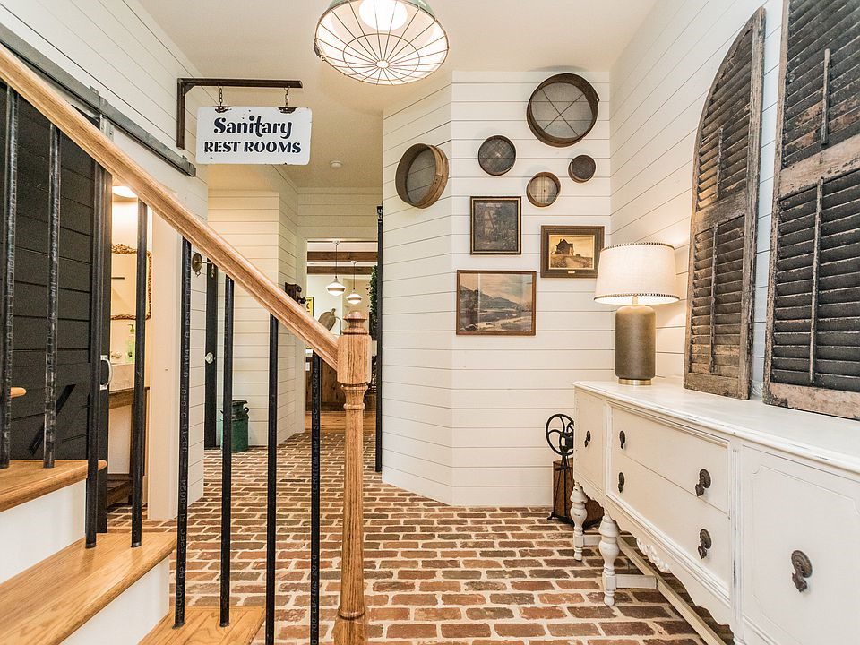 Brick flooring takes up the entire entryway and offsets the pure white walls.