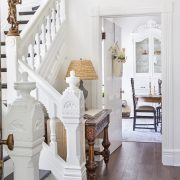 Entryway and staircase with white decor and hardwood floors in french farmhouse style