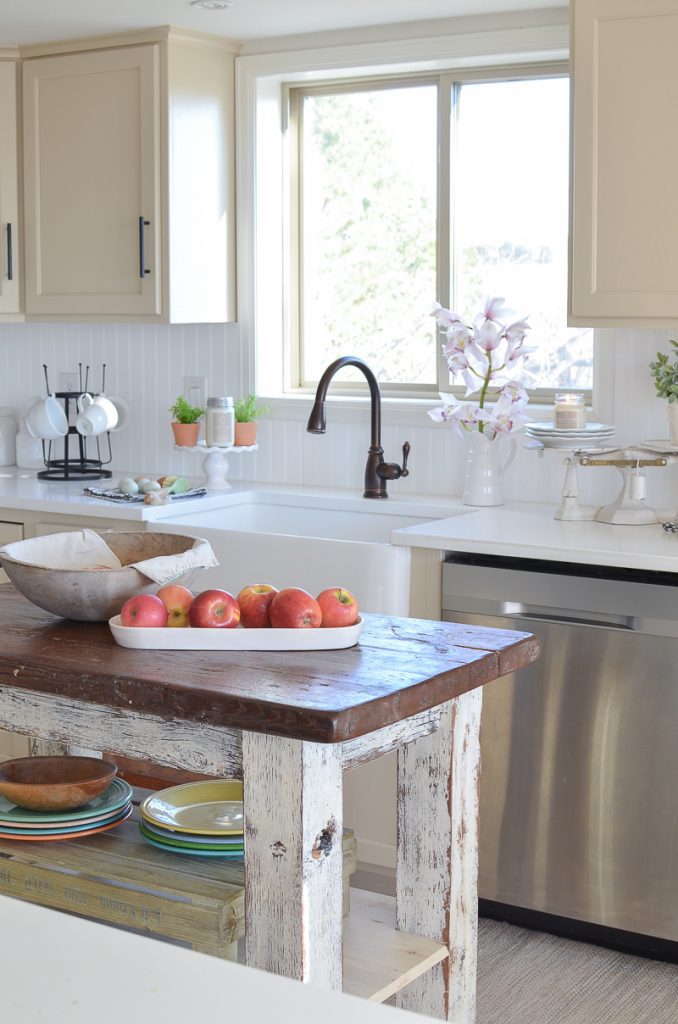 Sarah Joy Blog's farmhouse kitchen with rustic kitchen island, farmhouse sink, and window