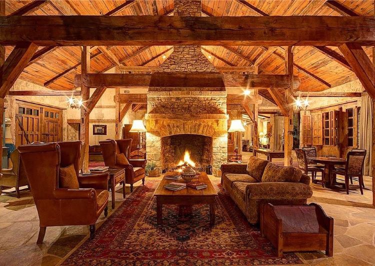 View of property's fireplace and exposed beams