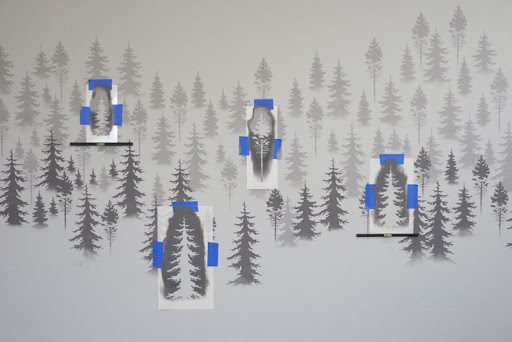 This wall mural is made up of many layers of tree stencils.