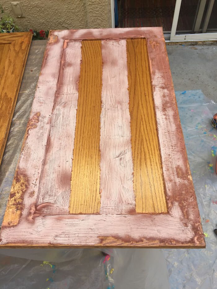 Stripping varnish off the cabinets to repaint kitchen cabinets