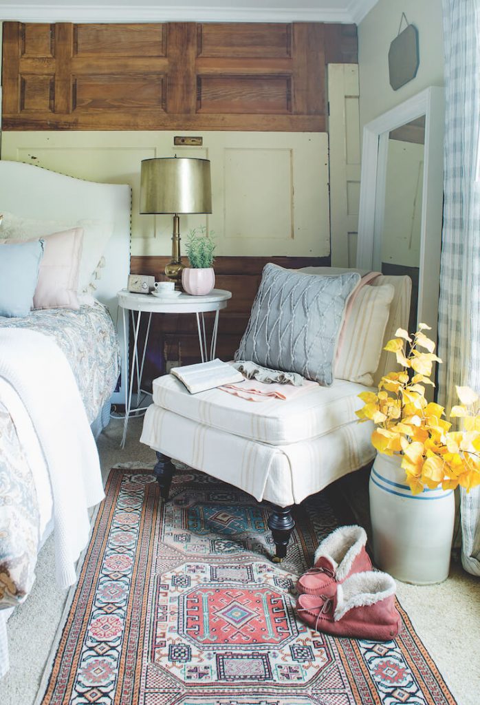 Farmhouse bedroom with cozy textiles and vintage door wall
